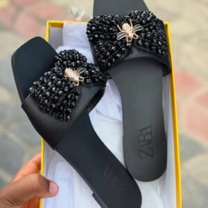 Zara Flat Sandals featuring a prominent, embellished bow detail