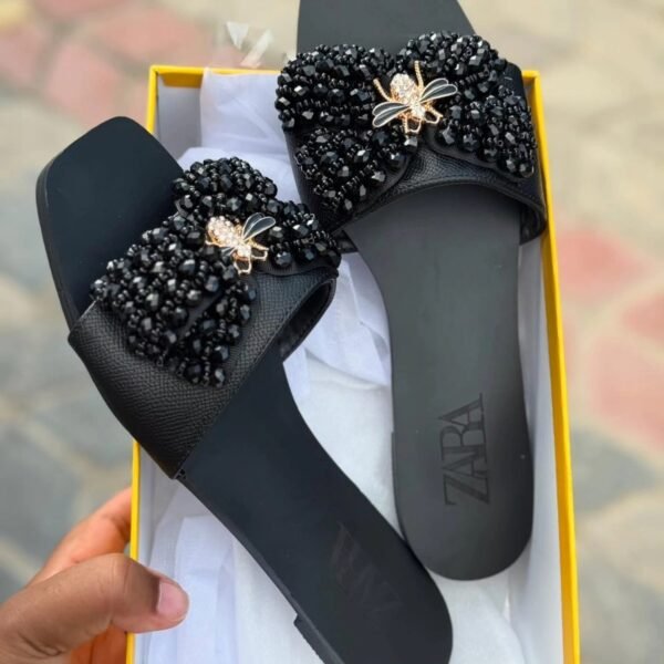 Zara Flat Sandals featuring a prominent, embellished bow detail
